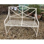 A modern white painted wrought iron garden bench