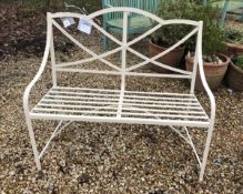 A modern white painted wrought iron garden bench