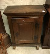 A 19th Century Dutch oak side cabinet the single panel door enclosing a single shelf and three