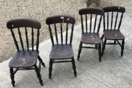 A set of four small stained beech stick back kitchen chairs,