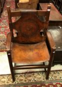 A circa 1900 oak and embossed leather throne type chair (believed to be Hungarian) the back panel