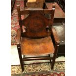 A circa 1900 oak and embossed leather throne type chair (believed to be Hungarian) the back panel