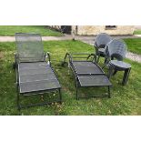 A pair of modern wrought iron sun loungers,