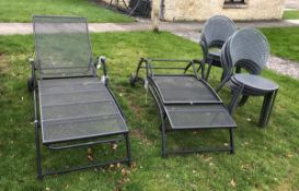 A pair of modern wrought iron sun loungers,