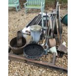 A large collection of garden tools to include a roller, an umbrella stand,