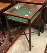 An Edwardian mahogany bijouterie table of square form raised on square supports united by an