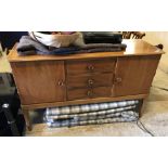 A Gordon Russell walnut sideboard with three central drawers flanked by two cupboard doors,