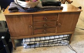 A Gordon Russell walnut sideboard with three central drawers flanked by two cupboard doors,