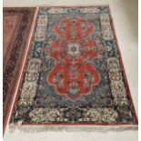 A fine Persian rug with centre medallion on a stylised leaf decorated red ground with floral spray