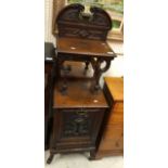 A circa 1900 mahogany coal purdonium with mirrored and shelves superstructure over a dolphin carved