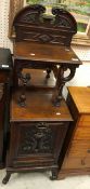 A circa 1900 mahogany coal purdonium with mirrored and shelves superstructure over a dolphin carved