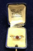 A yellow metal ring with rubies and diamonds