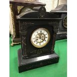 A late Victorian black marble cased mantel clock of architectural form,