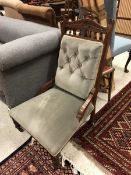 A Victorian walnut framed salon chair with button back raised on ringed and turned legs together