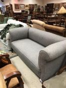 A circa 1900 scroll arm sofa with grey upholstery raised on cabriole legs CONDITION