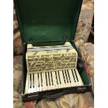 A Hohner Verdi II simulated mother of pearl veneered piano accordion with case