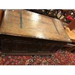 An 18th Century Dutch oak coffer the plain top with wrought iron hinges over a panelled front