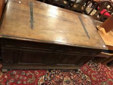 An 18th Century Dutch oak coffer the plain top with wrought iron hinges over a panelled front