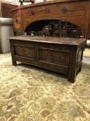 A Victorian carved oak coffer with lozenge medallion decorated panels