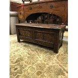 A Victorian carved oak coffer with lozenge medallion decorated panels