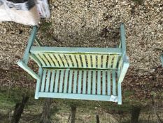 A modern wooden green painted garden bench