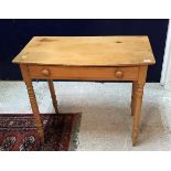 A pine single drawer side table with bow fronted top raised on turned legs