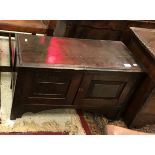 An 18th Century oak coffer of small proportions the rising top with molded edge over two panel