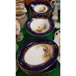 A collection of Royal Worcester game decorated dessert plates including circular plates and serving