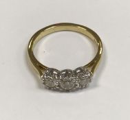 An 18ct gold three stone diamond ring ap