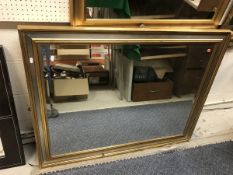 A modern gilt framed wall mirror
