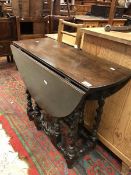 A 19th Century oak gate leg table on bar