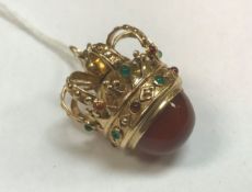 An eighteen carat gold and stone set pendant in the form of a crown