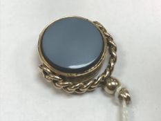 A Victorian nine carat gold stone set swivel fob opening as a locket