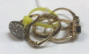 A collection of five various nine carat gold and stone set dress rings