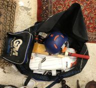 A Gunn & Moore cricket bag and contents