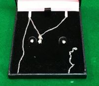 A diamond pendant and earring set