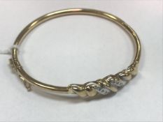 A nine carat gold and diamond set bangle