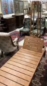 A teak day bed with adjustable head rest and an early 20th Century oak hat and coat stand