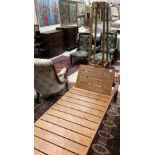 A teak day bed with adjustable head rest and an early 20th Century oak hat and coat stand