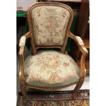 A Louis XV style stained beech open arm elbow chair on cabriole legs to scroll feet