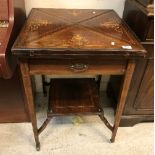 An Edwardian rosewood and marquetry inlaid envelope card table with single frieze drawer on square