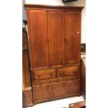 A Victorian mahogany housekeeper's cupboard three arch panel doors enclosing shelving over two four