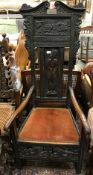 A Victorian carved oak framed hall chair in the 17th Century manner bearing plaque inscribed