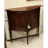 A 19th Century mahogany and satinwood strung two door side cabinet in the demilune form raised on