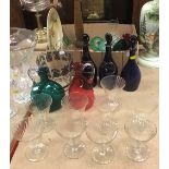 A collection of glassware to include three 19th Century Bristol blue decanters,