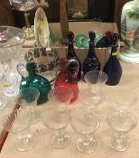 A collection of glassware to include three 19th Century Bristol blue decanters,