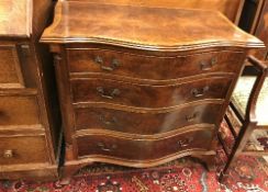 A reproduction mahogany serpentine fronted chest of four long drawers in the George III manner