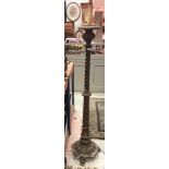 A gilt standard lamp with barley-twist column,