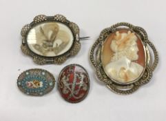 A collection of four brooches to include a Victorian mourning brooch with hair set to the interior,