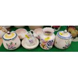 Seven pieces of Poole pottery including preserve pots, small dish,